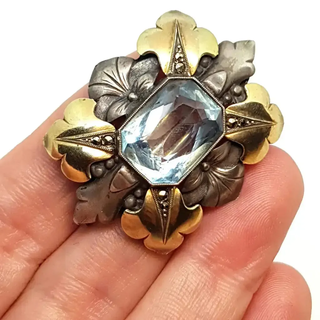 Art deco brooch. Silver pin made of silver, views of gold and simile of aquamarine.