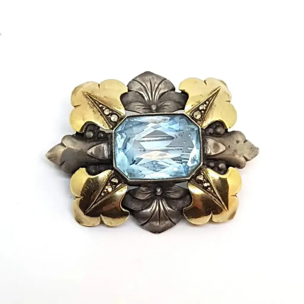 Art deco brooch. Silver pin made of silver, views of gold and simile of aquamarine.