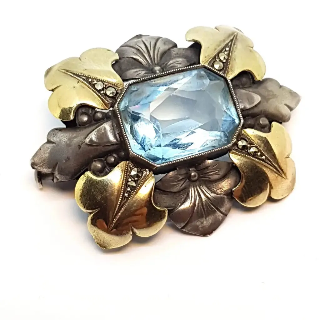 Art deco brooch. Silver pin made of silver, views of gold and simile of aquamarine.