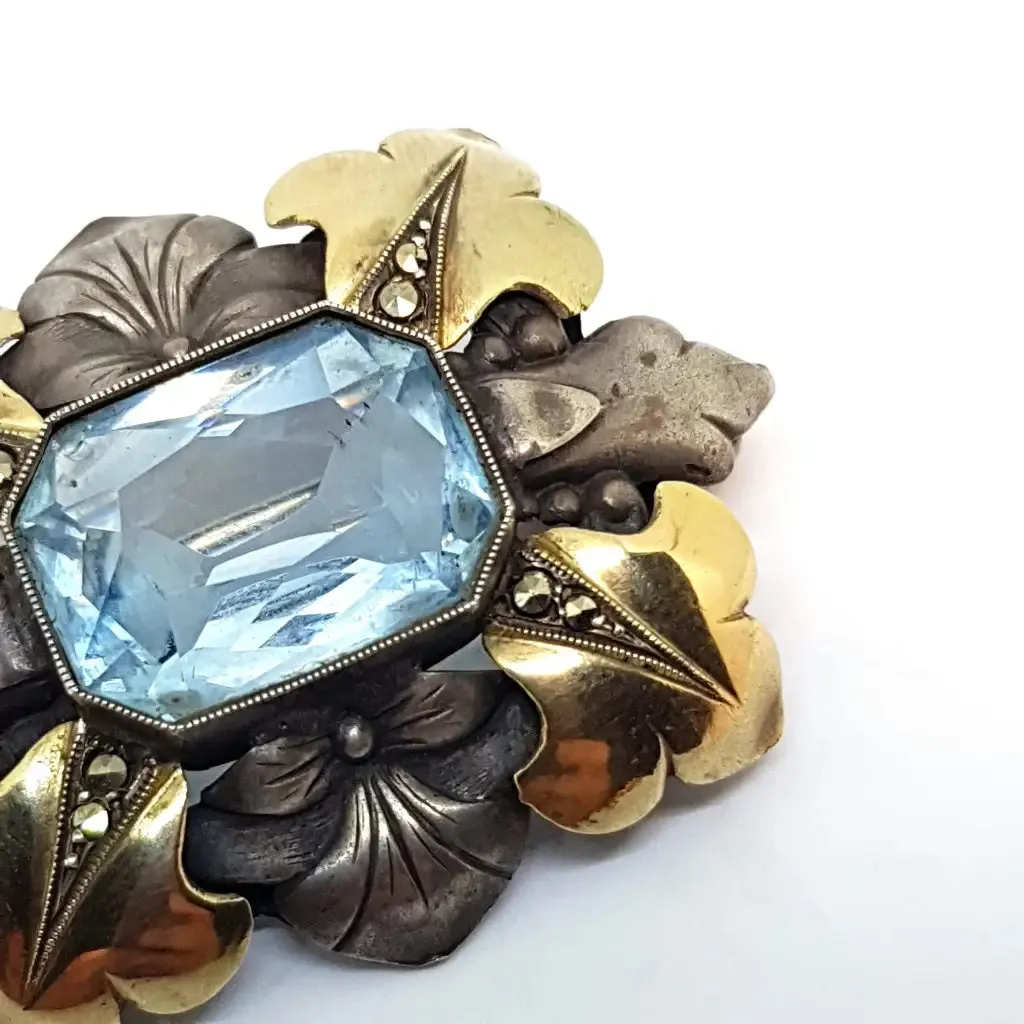 Art deco brooch. Silver pin made of silver, views of gold and simile of aquamarine.