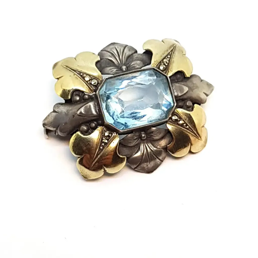 Art deco brooch. Silver pin made of silver, views of gold and simile of aquamarine.