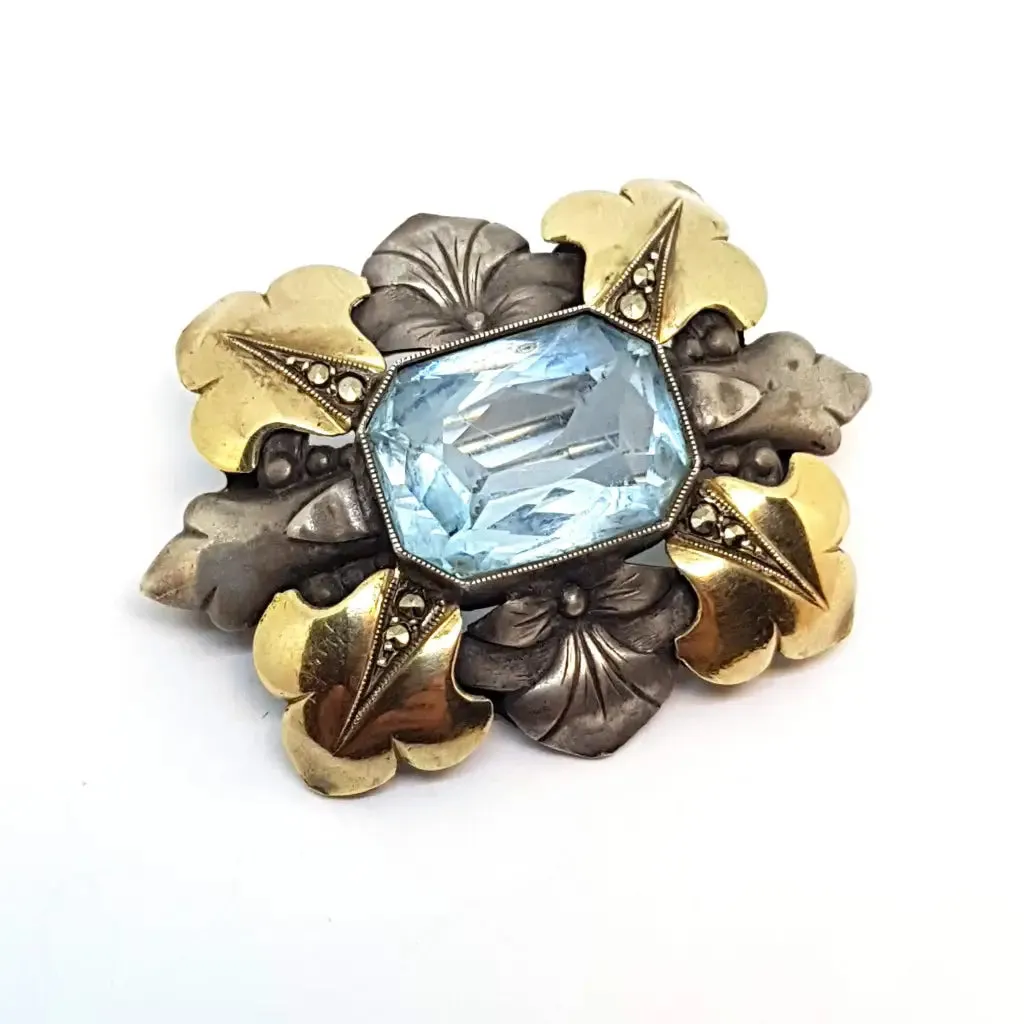 Art deco brooch. Silver pin made of silver, views of gold and simile of aquamarine.
